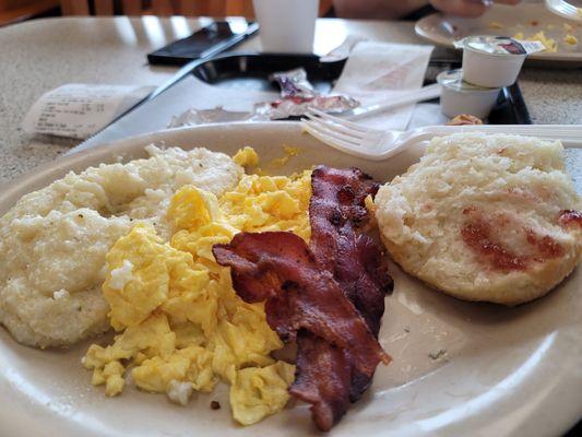 Grits, cheese and grits , bacon Home made biscuit Jelly  and coffee.