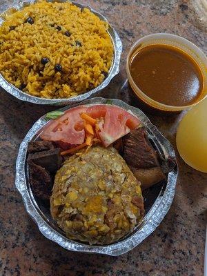 Mofongo with a side of gravy. With some delicious yellow rice and beans to boot.