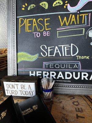 Please wait to be seated - Don't be a turd today.