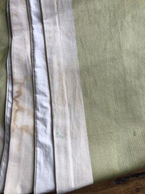 Dirt, stains, and grime still on linens after I took them home.