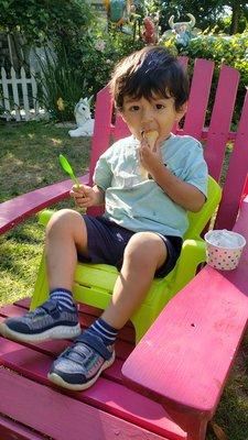 Chairs for everyone in  a spacious garden.   Those little  green Andirondack chair are perfect for kids.