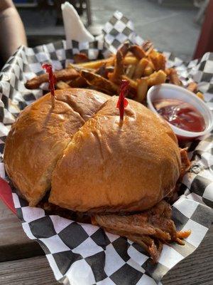 Pulled pork sandwich with fries.