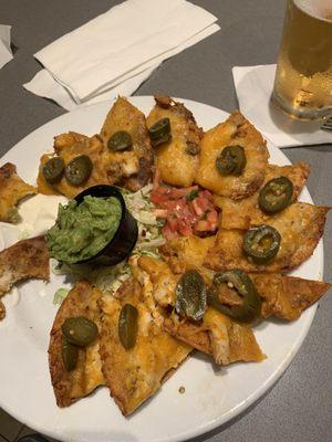 Classic nachos w/chicken and guacamole, both extra charge. Disgusting to even look at, and worse to eat.