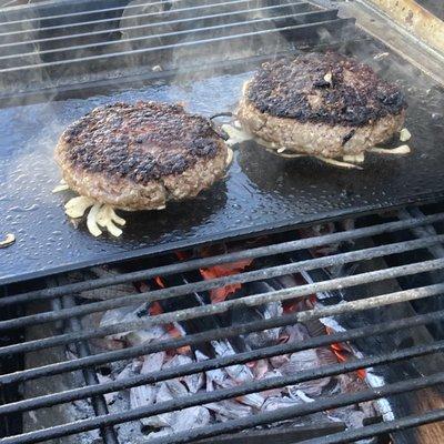 Steak burgers on the griddle over hickory wood