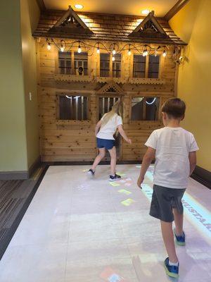 Interactive floor game and play house in the waiting room