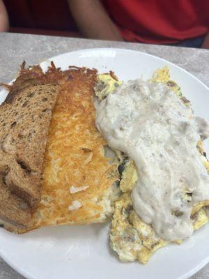 Crossroads omlet smothered in sausage gravy with hash browns and wheat toast.