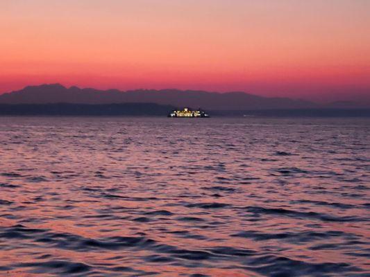 In the distance a ferry boat taking western Washington residents home.