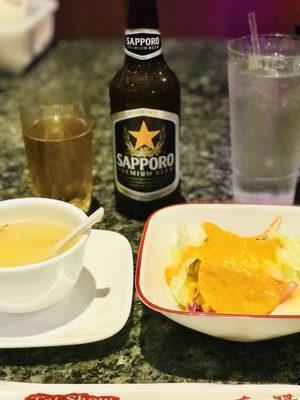 A Sapporo Authentic Japanese Beer with A Frosted Glass, Chicken Noodle Soup, & A Ginger Dressing Salad to Start it Off.