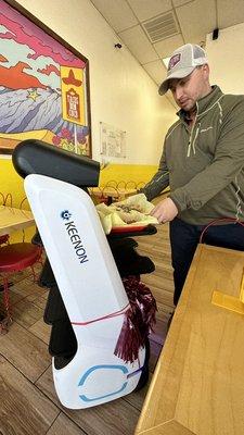 A robot delivers your food to the table. Really fun.