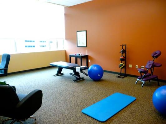 Spacious treatment room for chiropractic adjustments and therapies.