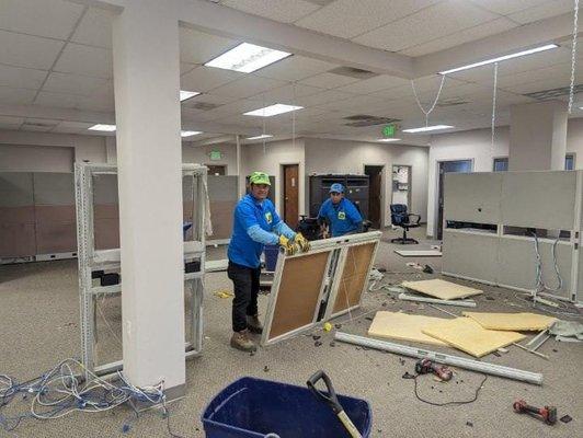 Our friendly team breaks down the cubicles in this office space.