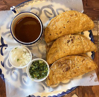 Birria tacos with cilantro, onion, consume (hot sauce not pictured)