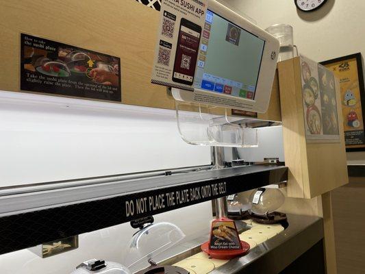 The conveyor belt and the tablet to place order