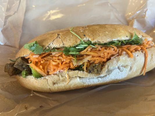 Large vegetarian tofu banh mi ($10.75). Baguette, curry tofu, pickled carrot and radish, cilantro, jalapeño, and garlic mayo.