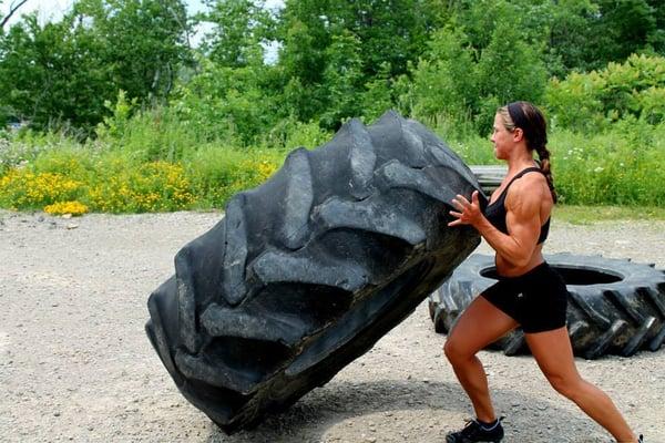 Coach Megan moving throwing around some heavy tires!