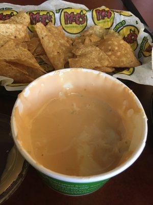 Not quite white queso and over baked chips.