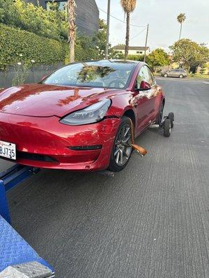 Performing dolly towing. Tesla Towing. Wheel Lift Towing