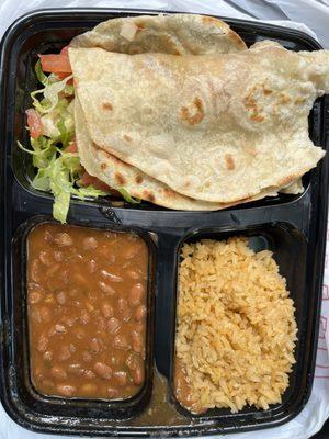 Picadillo tacos, with lettuce tomato and cheese, side of beans and Spanish rice