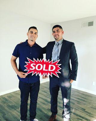 Agent Clinton Jones with his client who purchased his first condo.