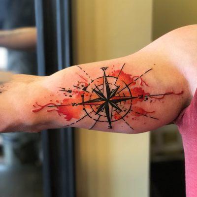 Colorful warm toned compass tattoo