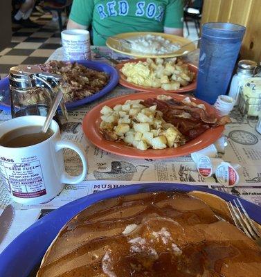 pancakes, eggs, hash, coffee, bacon, biscuits and gravy, home fries