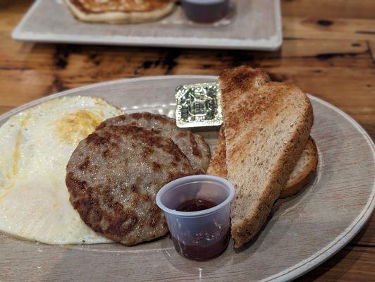 Eggs over medium, pork sausage, wheat toast, it was alright.