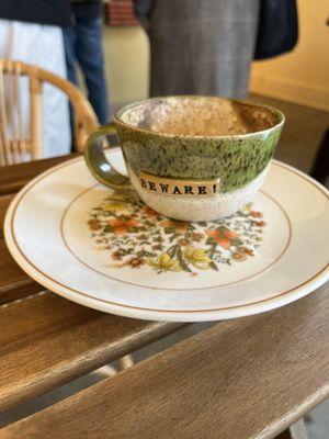 Finished matcha mocha mug and empty pastry plate