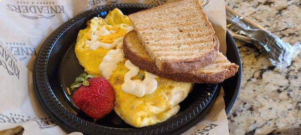 Mexican Omelet - 3 ounce scrambled omelet with Pico De Gallo, cheddar cheese and crema. Served with toast and a fresh strawberry.