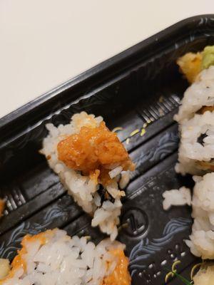 The mushy spicy tuna roll after trying to pick up an adjacent roll