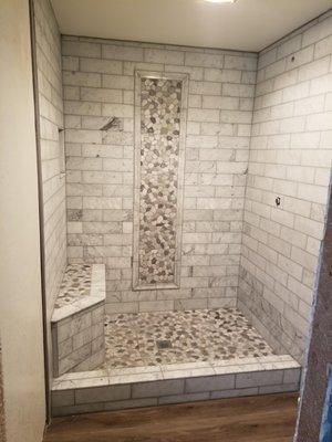 Removed tub and built shower with marble tiles