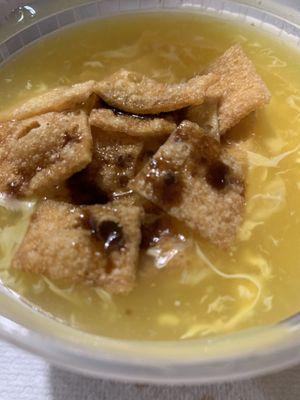 Egg drop soup with crispies on top.