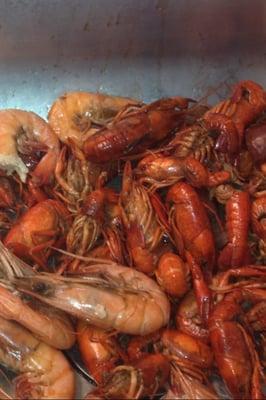 Crawfish and shrimp, cooked or live. They also sell gator meat.