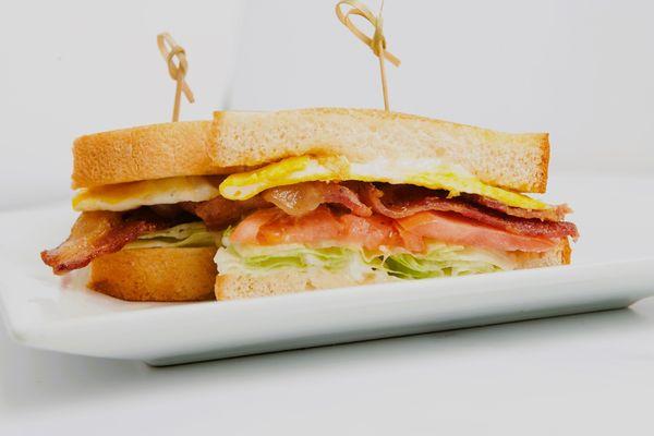 "BLTE Sandwich: A delightful twist on a classic BLT, featuring the perfect crunch of lettuce, savory bacon, fresh tomato, and a kick of egg!