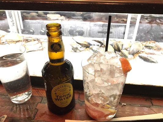 Grapefruit G&T beautifully displayed in front of clams on ice!   Fanciest tonic water in nyc at Cata