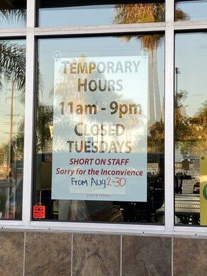 Temporarily closed on TUESDAY's sign at John's on Spring Street in Long Beach, CA window sign for Tue 8/2-30/2021