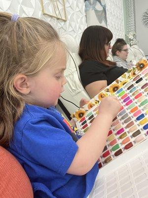 Daughter picking our nail colors.