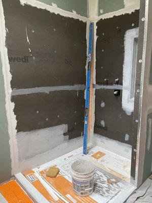 Shower enclosure showing high quality wallboard and shower pan.