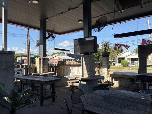 Outdoor seating area with TVs and fans!