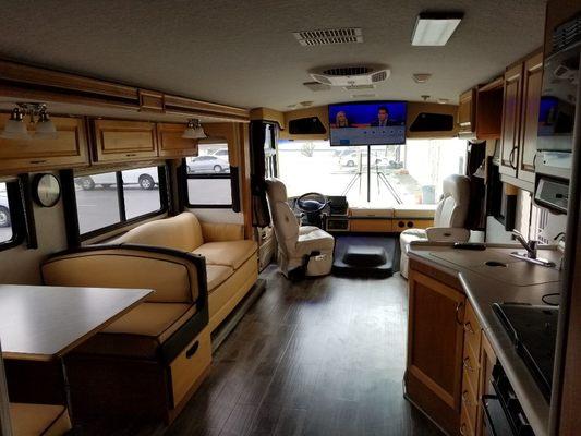 Rv after complete reupholstering  with wood flooring  complete sound upgrade with 40 inch smart tv