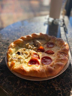 Half pesto mushroom garlic and half pepperoni pizza