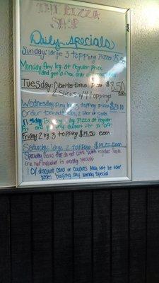 Their white board behind the cashier with their daily specials.