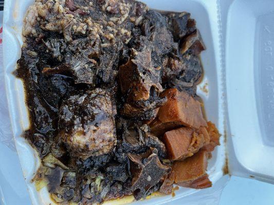 Medium oxtail platter with candy, yams, and cabbage