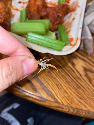 Chickens hair still on chicken wings.