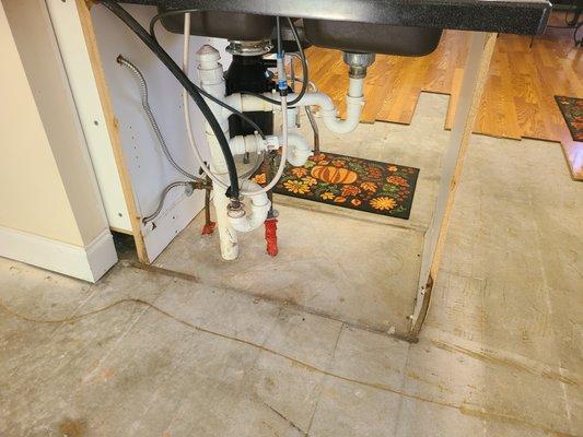 Under cabinet sink and flooring damage to Kitchen and sunroom.