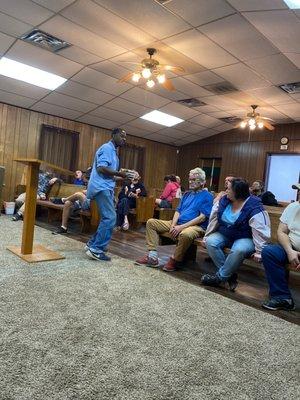 Minister Brian Tucker sharing with participants of the food outreach ministry.