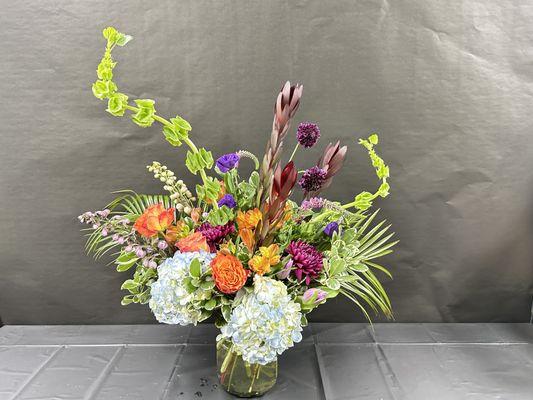 Bright and cheery fresh cut flower arrangement in a clear vase