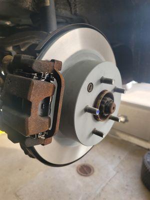 New rear brake pad and rotors on an Infinity.