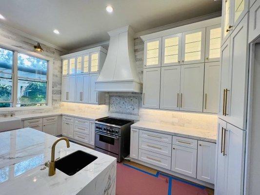 Custom wood hood and stacked glass cabinets