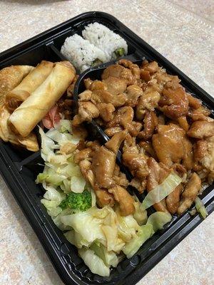 Chicken Bento with vegetables, fried rice, spring roll, California sushi