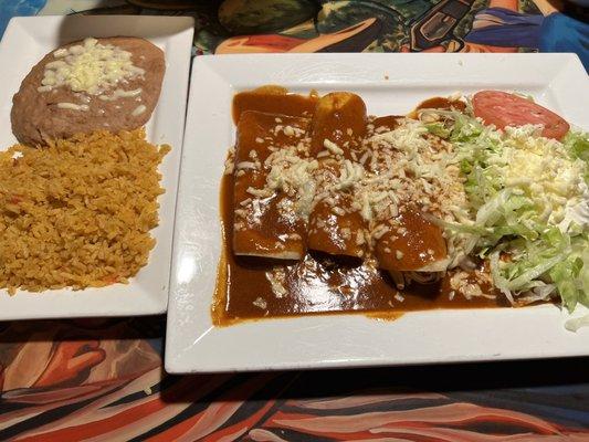 Enchiladas Supremas with side of rice and beans